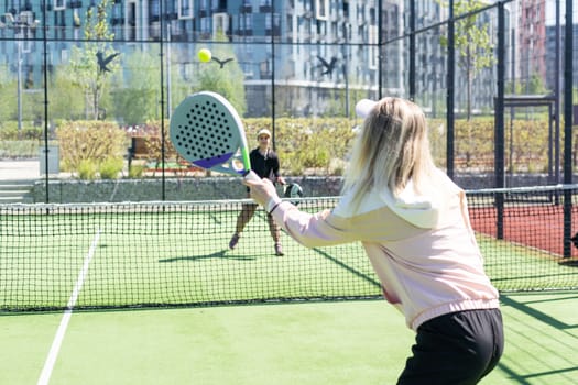 mother and daughter play padel. High quality photo