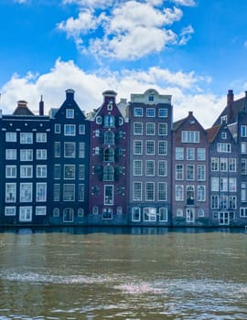 A picturesque scene of a majestic row of buildings standing tall next to a tranquil body of water, creating a harmonious blend of architecture and nature. Amsterdam Netherlands 21 April 2024