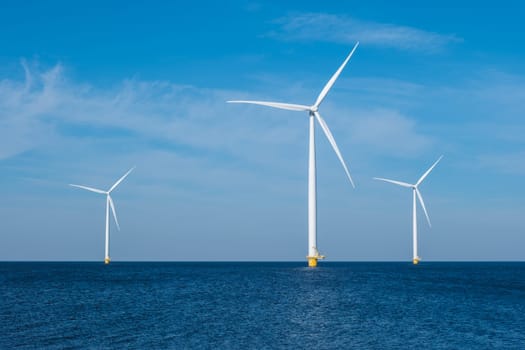 A group of elegant wind turbines stands tall in the ocean in the Netherlands Flevoland, harnessing the power of the wind to generate renewable energy. Windmill turbines at sea,