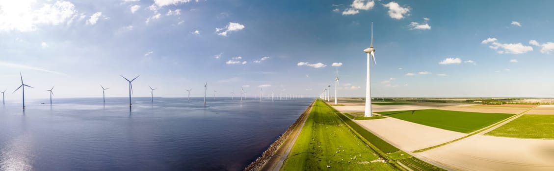 A vast expanse of water surrounded by towering windmills in Flevoland, Netherlands, harnessing the power of the wind to generate renewable energy. Banner of Windmill turbines at sea