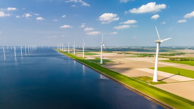 A serene large body of water surrounded by windmills, which are actively generating electricity with the power of the wind.