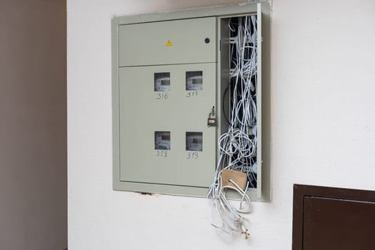 Electric cabinet with Internet and television cables in an apartment building. Niche for wires and cables inside the wall.