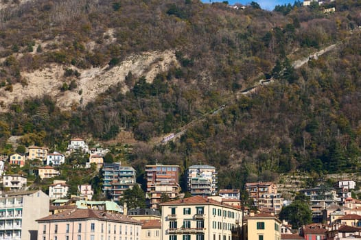 Como Lago. Italian city of Como in Alps mountains. Beautiful houses in mountain. Travel. Buildings. Tourism concept. Italy, Lombardy, the province of Milan.