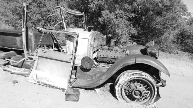 Black and White Rusty Old Car Abandoned in California Desert. High quality photo