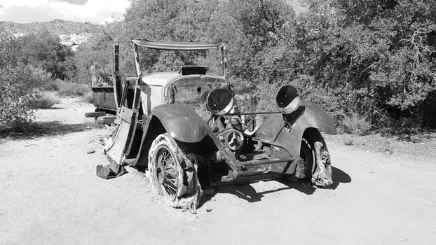 Black and White Front View of Rusty Old Car Abandoned in California Desert. High quality photo