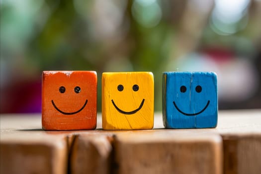 Three wooden blocks with smiling faces on them. The blocks are arranged in a row, with the yellow block in the middle and the red and blue blocks on either side. The arrangement creates a cheerful. Generative AI