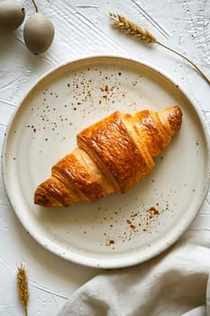 Croissant on plate with wheat and napkin. Generative AI.