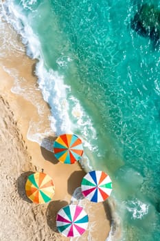 Colorful umbrellas on the beach. Generative AI.