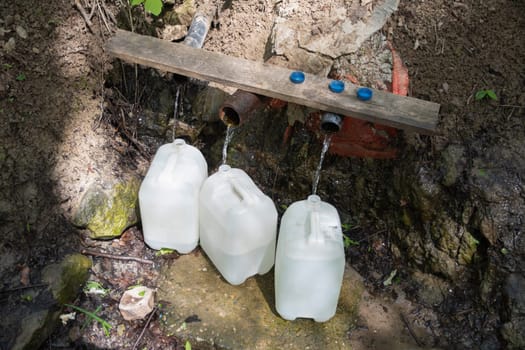 An underground source of clean fresh water, filled canisters for a home supply of essential products, high quality photo