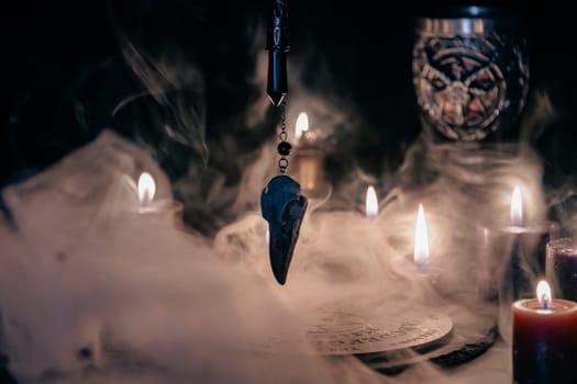 A mysterious and atmospheric occult setting featuring a pendulum swinging over a mystic symbol, surrounded by candlelight and fog