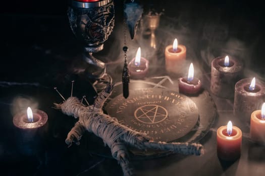 A chilling scene of an occult ritual featuring a voodoo doll pinned with needles, surrounded by candles, a pentagram, and eerie smoke