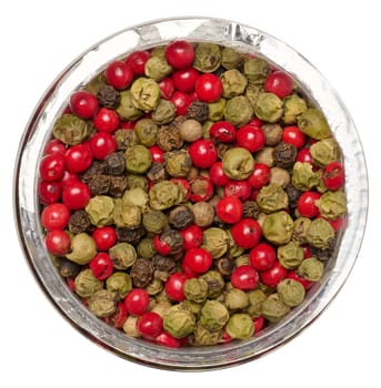 Mix of red, black and green peppercorns in a jar on an isolated background, top view