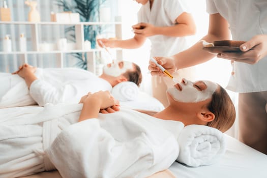 Serene ambiance of spa salon, couple indulges in rejuvenating with luxurious face cream massage with modern daylight. Facial skin treatment and beauty care concept. Quiescent