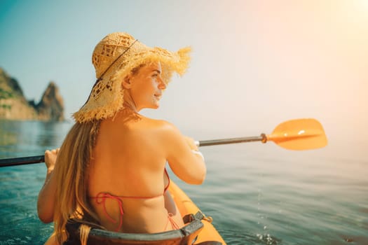 A woman wearing a straw hat is paddling a canoe on a sunny day. Scene is relaxed and carefree, as the woman enjoys her time on the water
