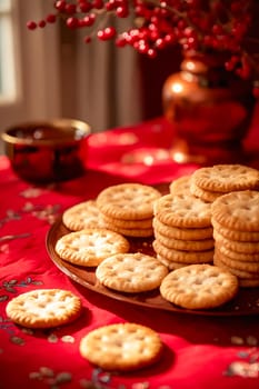 A plate of cookies is on a red tablecloth. The cookies are stacked on top of each other and there are several bowls and vases on the table. Scene is festive and inviting. Generative AI