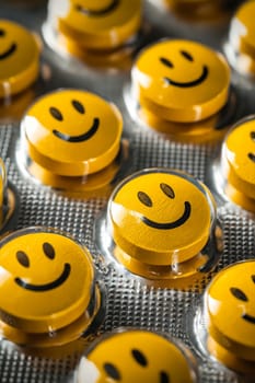 A row of yellow pills with smiling faces on them. Generative AI