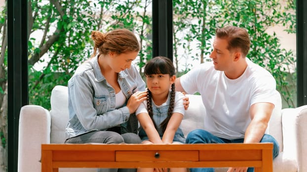 Parents comforting their daughter with loving hug, helping her feel secure and protected from fear, rest her head on shoulder. Happy family love and child care support concept. Panorama Synchronos