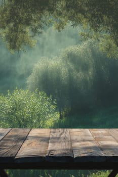 Sunlit wooden table overlooking a dreamy, misty forest landscape