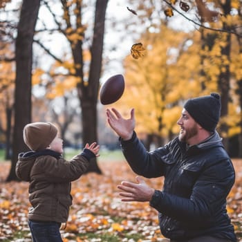 Smiling father catching a football in a park during the vibrant autumn season