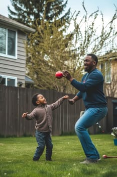 African-American father teaches son how to play baseball in their sunny backyard