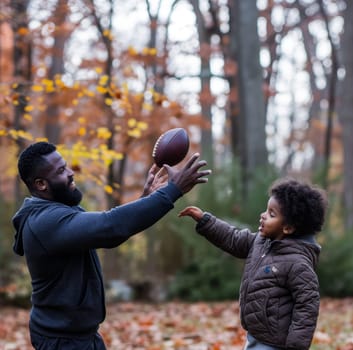 Father and son sharing a joyous moment playing football on a sunny day