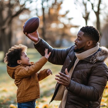 Smiling father catching a football in a park during the vibrant autumn season