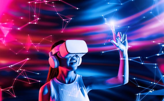 Smart female standing in cyberpunk style building in meta wear VR headset connecting metaverse, future cyberspace community technology, Elegant woman using fingers touch virtual object. Hallucination.