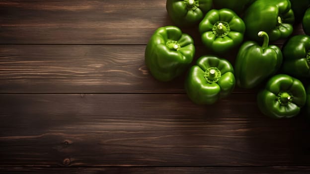 Banner: Green bell peppers on wooden background. Top view with copy space.