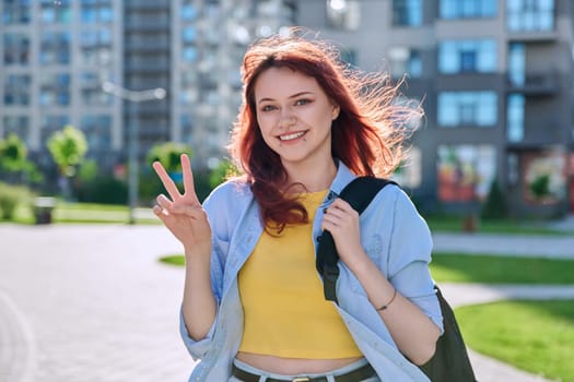 Young smiling beautiful attractive red-haired hipster female with facial piercing looking at camera outdoor. Beauty, fashion, piercing, style, lifestyle youth concept