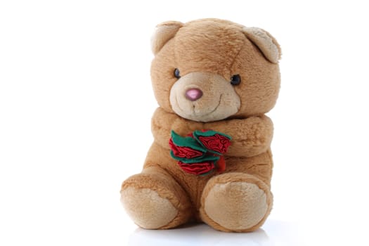 A cute Teddy Bear with roses