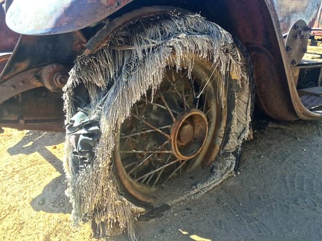 Frayed Decaying Antique Car Tire on Old Vehicle Rusting in California Desert. High quality photo