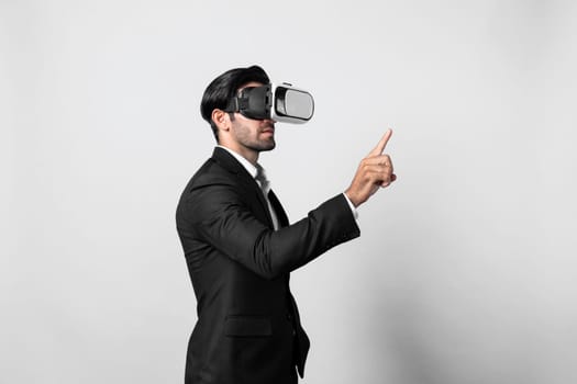 Project manager with virtual reality glasses looking at data analysis while analyzing and pointing data. Skilled business man using VR goggle and digital innovation while enter metaverse. Deviation.