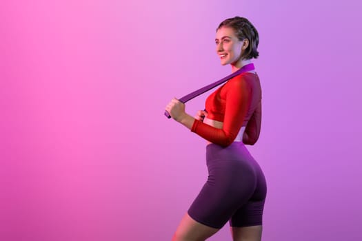 Full body length gaiety shot athletic and sporty young woman with fitness elastic resistance band in standing posture on isolated background. Healthy active and body care lifestyle.