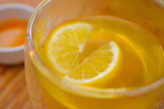 Top view of lemon tea pouring in a cup .