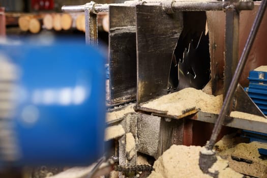 Image of machine for cutting and sawdust around, close-up