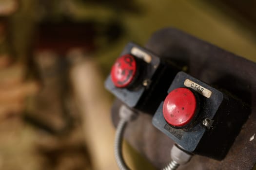 Machine control panel with two red buttons, close-up