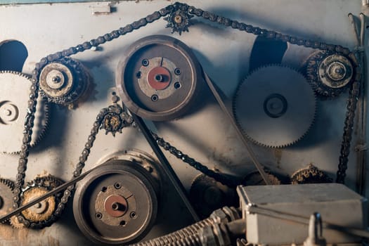 At sawmill. Image of gears and chain on machine