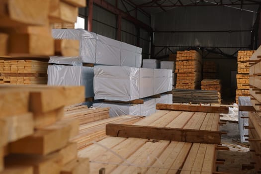 Warehouse at sawmill. Image of stacked wooden boards