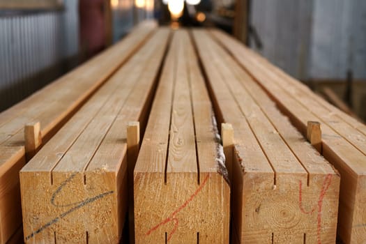 Image of wooden beams with cuts and color marks, close-up