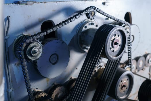 Close-up of chain stretched over gears on machine