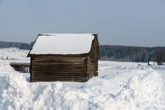 Winter time. Image of wooden house in village