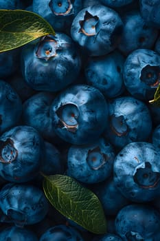 A pile of azure blueberries with vibrant green leaves, resembling an electric blue pattern. These natural foods are a staple food and a local delicacy, grown from flowering plants