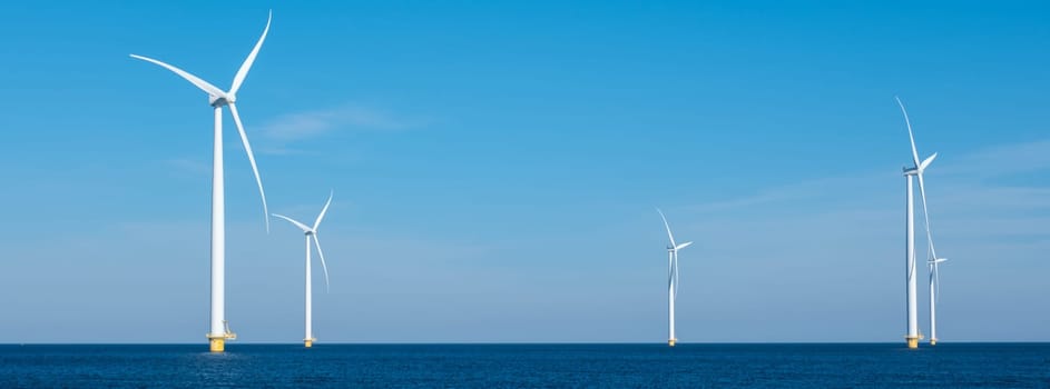A mesmerizing view of a row of wind turbines gracefully spinning in the vast ocean, capturing the power of renewable energy. Windmill turbines at sea, green energy transition in Europe