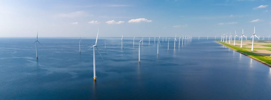 A vast body of water in Flevoland, with numerous towering windmills dotting the landscape.