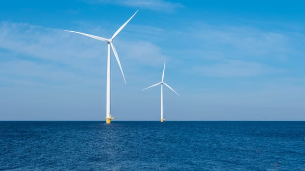 Two majestic wind turbines stand tall in the vast ocean, capturing the power of the wind and generating renewable energy for the Netherlands. Earth Day, copy space