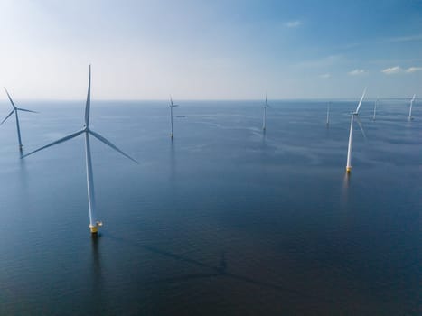 A group of windmills with turbine blades peacefully float atop the calm waters of Flevoland, Netherlands, creating a harmonious and picturesque scene.