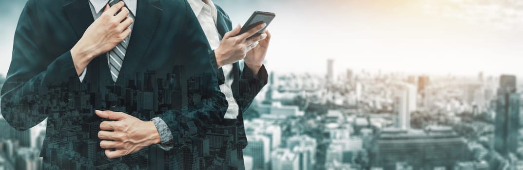 Double Exposure Image of Business Communication Network Technology Concept - Business people using smartphone or mobile phone device on modern cityscape background. uds