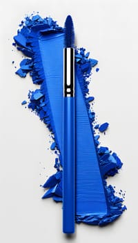 An electric blue fashion accessory lays on top of a pile of vibrant blue powder, resembling an annual plant against a backdrop of a window and a door