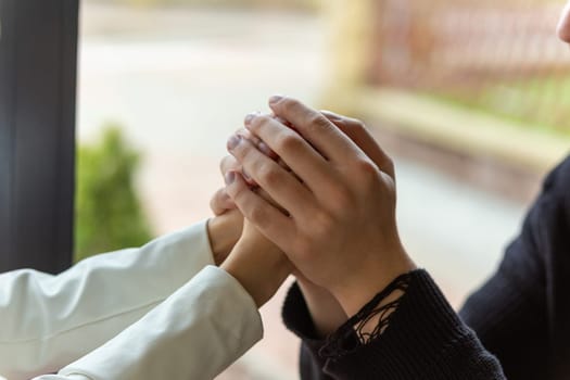 Couple enjoying a coffee holding hands. Holding hands, the hands of a couple who love each other. Bokeh portrait photo concept.