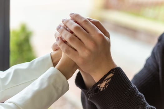 Couple enjoying a coffee holding hands. Holding hands, the hands of a couple who love each other. Bokeh portrait photo concept.